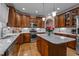 Well-equipped kitchen featuring wood cabinets, granite countertops, and stainless steel appliances at 9013 Dansforeshire Way, Wake Forest, NC 27587