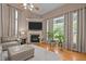 Inviting living room with fireplace, large windows, hardwood floors, and a neutral color palette at 9013 Dansforeshire Way, Wake Forest, NC 27587