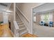 Staircase leading to a carpeted living room with lots of natural light at 9013 Dansforeshire Way, Wake Forest, NC 27587