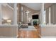 Spacious living area with soaring ceilings, hardwood floors, fireplace, and elegant columns at 9013 Dansforeshire Way, Wake Forest, NC 27587