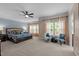 Spacious primary bedroom with carpeted floors, lots of light, and a ceiling fan at 9013 Dansforeshire Way, Wake Forest, NC 27587