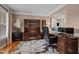 Spacious home office with wooden furniture, a comfortable chair, and a view to another room at 9013 Dansforeshire Way, Wake Forest, NC 27587