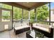 Relaxing screened porch with cushioned seating, overhead fan, and views of the landscaped backyard at 9013 Dansforeshire Way, Wake Forest, NC 27587