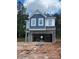 Two story home with unfinished landscaping and stone accents. Two-car garage in need of completion at 1001 Shovelhead Dr # 1, Durham, NC 27703