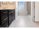 Bright bathroom featuring dark vanity, framed wall art, and glass enclosed shower at 1004 Sora Way, Durham, NC 27703