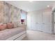 Comfortable bedroom with stylish wallpaper and storage options, maximizing space and appeal at 1004 Sora Way, Durham, NC 27703