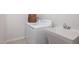 Well-equipped laundry area with washer, sink, and basket, offering convenience and functionality at 1004 Sora Way, Durham, NC 27703