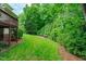 Lush backyard with mature landscaping and natural surroundings at 102 Lions Mouth Ct, Cary, NC 27518