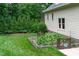 Lush backyard featuring a garden and manicured lawn at 102 Lions Mouth Ct, Cary, NC 27518
