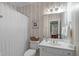 Neutral bathroom featuring a single sink vanity, decorative wallpaper and a shower/tub with curtain at 102 Lions Mouth Ct, Cary, NC 27518