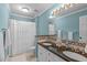 Bathroom with double sinks, granite counters, and a shower-tub combination with a white curtain at 102 Lions Mouth Ct, Cary, NC 27518