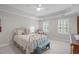 Inviting bedroom boasts trey ceilings, a ceiling fan, shuttered windows, and comfortable furnishings at 102 Lions Mouth Ct, Cary, NC 27518