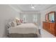 This bedroom showcases comfort and style, with a trey ceiling, wooden dresser, and inviting window light at 102 Lions Mouth Ct, Cary, NC 27518