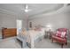 This comfortable bedroom has a classic chair, wooden dresser and trey ceiling, offering relaxation and style at 102 Lions Mouth Ct, Cary, NC 27518