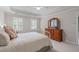 This bedroom offers a bright and spacious retreat with shuttered windows and a large wooden dresser at 102 Lions Mouth Ct, Cary, NC 27518