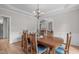 Elegant dining room featuring a chandelier, hardwood floors, and classic wainscoting at 102 Lions Mouth Ct, Cary, NC 27518