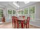 Bright dining room with skylights and many windows with shutter-style blinds at 102 Lions Mouth Ct, Cary, NC 27518