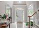 Bright foyer with an arched doorway, tiled floor, and staircase at 102 Lions Mouth Ct, Cary, NC 27518