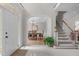 Open foyer leading to the dining room with staircase at 102 Lions Mouth Ct, Cary, NC 27518