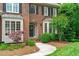 Close-up of a home's front door with bay windows and manicured shrubbery at 102 Lions Mouth Ct, Cary, NC 27518