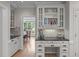 Charming kitchen featuring built-in shelving, granite countertops, and a view into a bright, inviting dining room at 102 Lions Mouth Ct, Cary, NC 27518
