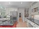 Bright kitchen featuring stainless steel appliances, granite countertops, white cabinets, and a red central island cooktop at 102 Lions Mouth Ct, Cary, NC 27518