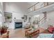 Spacious living room with fireplace, built-in shelving, and two-story windows to let in natural light at 102 Lions Mouth Ct, Cary, NC 27518