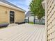 The backyard deck offers ample seating with a wooden bench and blue railing at 102 Westside Dr, Chapel Hill, NC 27516