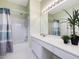 Bathroom with tub, shower, vanity, and a decorative plant at 102 Westside Dr, Chapel Hill, NC 27516