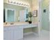 Bathroom featuring a spacious vanity with dual mirrors and ample lighting at 102 Westside Dr, Chapel Hill, NC 27516