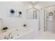 Bathroom featuring a soaking tub and a glass shower, decorated with modern paintings at 102 Westside Dr, Chapel Hill, NC 27516