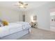 A well-lit bedroom features neutral tones, a ceiling fan and access to a bathroom at 102 Westside Dr, Chapel Hill, NC 27516