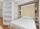 This bedroom features a Murphy bed and built-in shelving, perfect for space-saving and organization at 102 Westside Dr, Chapel Hill, NC 27516