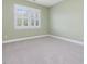 Bedroom with plush carpet and a bright window at 102 Westside Dr, Chapel Hill, NC 27516