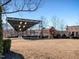 Large community green space featuring an outdoor covered stage and neighborhood buildings in the background at 102 Westside Dr, Chapel Hill, NC 27516