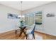 Bright dining room with a glass table, stylish chairs, and large windows offering plenty of natural light at 102 Westside Dr, Chapel Hill, NC 27516