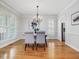 Elegant dining room featuring natural light, wood floors, and stylish chandelier at 102 Westside Dr, Chapel Hill, NC 27516