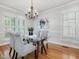 Beautiful dining room with wood floors, modern chandelier, and bright, natural light at 102 Westside Dr, Chapel Hill, NC 27516
