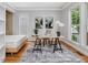 Bright home office with large windows, hardwood floors, a bed, modern decor, and artwork at 102 Westside Dr, Chapel Hill, NC 27516
