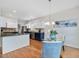 Open kitchen and dining area with white cabinets, stainless steel appliances, and a granite countertop island at 102 Westside Dr, Chapel Hill, NC 27516