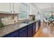 Stylish kitchen with granite counters, tiled backsplash, stainless steel appliances and ample natural light by the dining area at 102 Westside Dr, Chapel Hill, NC 27516