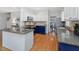 Well-equipped kitchen featuring granite countertops, stainless steel appliances, and white and blue cabinetry at 102 Westside Dr, Chapel Hill, NC 27516