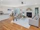 Bright living room featuring a fireplace, ceiling fan, and an open floor plan flowing into the dining area at 102 Westside Dr, Chapel Hill, NC 27516