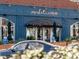 Market and Moss store front featuring hanging lights, awnings, and outdoor greenery for a welcoming atmosphere at 102 Westside Dr, Chapel Hill, NC 27516