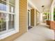 Inviting front porch featuring classic columns, ceiling fan and ample space for relaxing at 102 Westside Dr, Chapel Hill, NC 27516