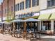 Al's Burger Shack with outdoor seating, featuring picnic tables and umbrellas, in a vibrant commercial area at 102 Westside Dr, Chapel Hill, NC 27516