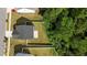 An aerial view of the home's roof and backyard featuring green grass and trees at 1028 Gallivant Way, Wake Forest, NC 27587