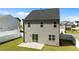 The back exterior view of a two-story home with sliding glass doors to a concrete patio at 1028 Gallivant Way, Wake Forest, NC 27587