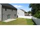 A backyard featuring green grass, a concrete patio, and a white privacy fence at 1028 Gallivant Way, Wake Forest, NC 27587