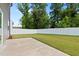 A spacious backyard with healthy green grass is surrounded by a privacy fence and mature trees at 1028 Gallivant Way, Wake Forest, NC 27587